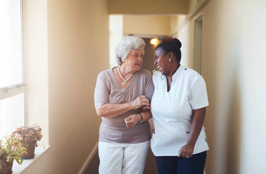 A staff member laughing with a resident.