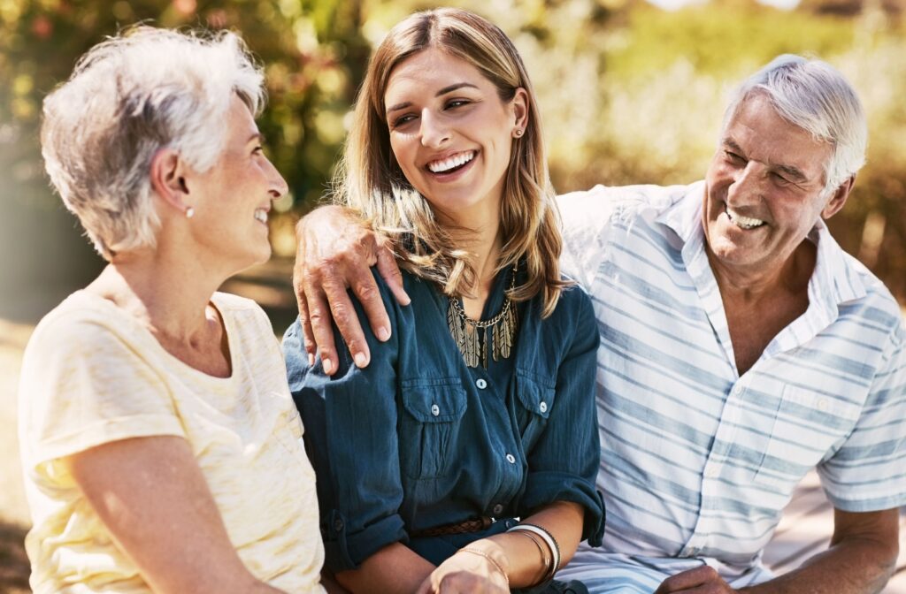 A young woman talking to her elderly parents about choosing a senior living community